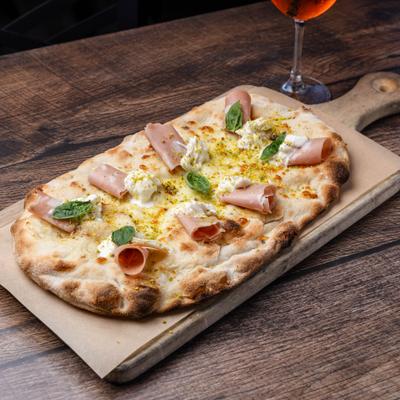 Pizza with salami, ricotta, and basil