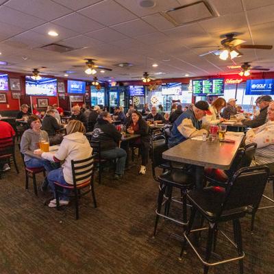 Busy sports bar dining room with televisions.