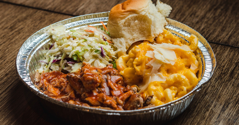 Grilled sliced meat, bread and salad on the side