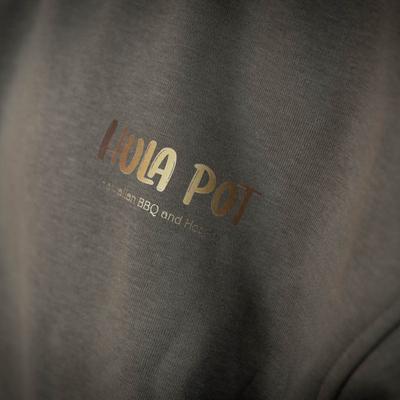 ''Hula Pot'' logo on the dark gray hoodie, zoomed in.