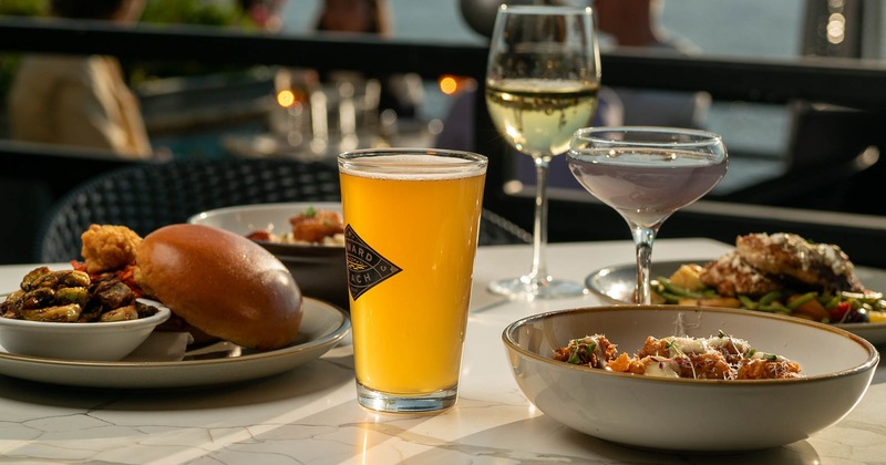 A table with multiple dishes and drinks