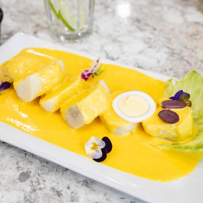 Sliced boiled potatoes smothered in a creamy, spicy yellow cheese sauce.