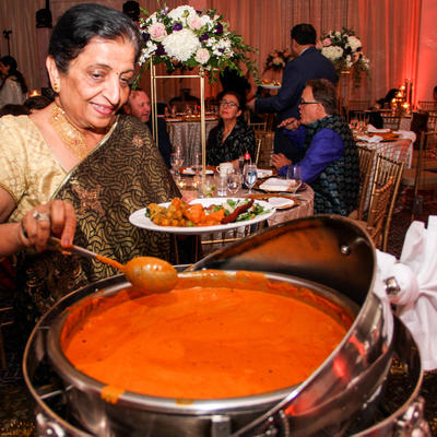 Guest pouring orange sauce