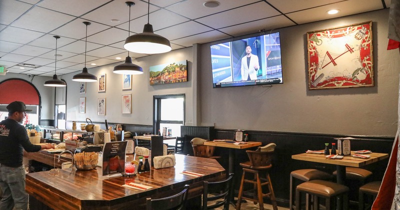 Interior, tables and chairs, tv on the wall