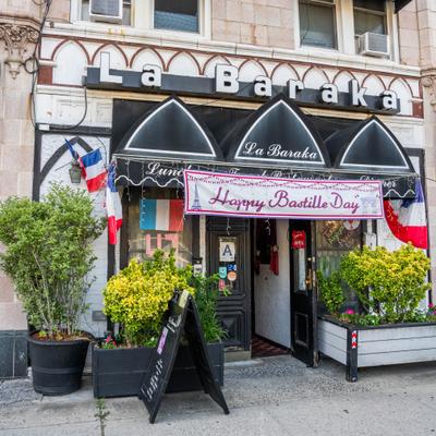 Restaurant front entrance with decorative plants.