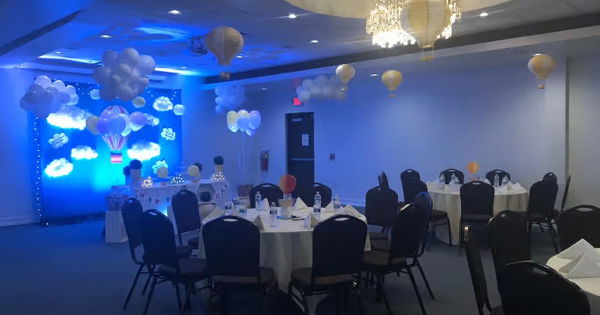 A banquet hall decorated for a celebration with hot air balloon theme