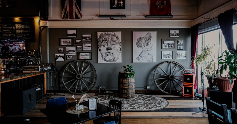 Interior, tables ready for guests with decorations in the back
