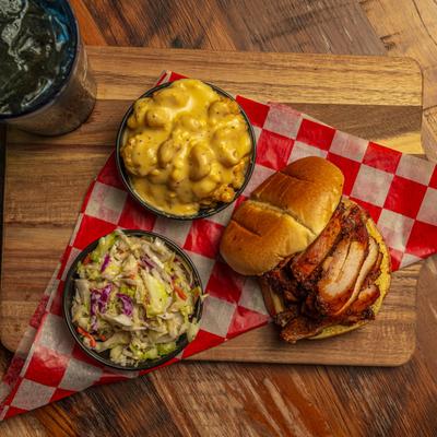 Chicken sandwich, served with coleslaw, and mac and cheese.