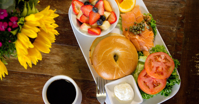 Pastry, salad, fish, fruit salad and coffee on the side