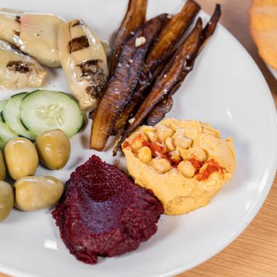 Mediterranean platter with vegetables and dips.