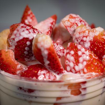 Strawberry milkshake topped with fresh strawberries.
