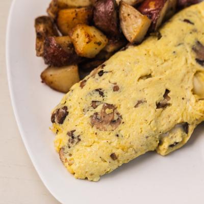 Mushroom omelet served with home fries.