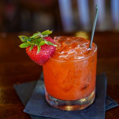 Day by the Peach cocktail garnished with a strawberry.