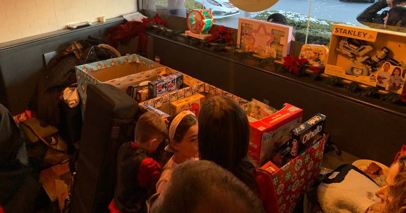 Children surrounded by gift boxes and toys
