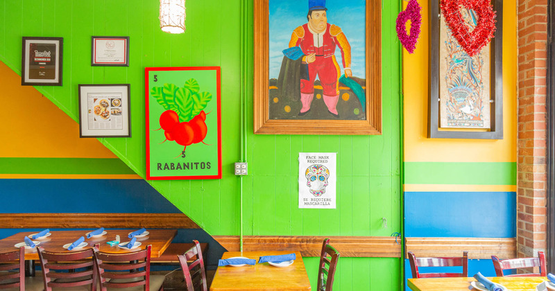 Interior, tables and chairs with pictures on the wall