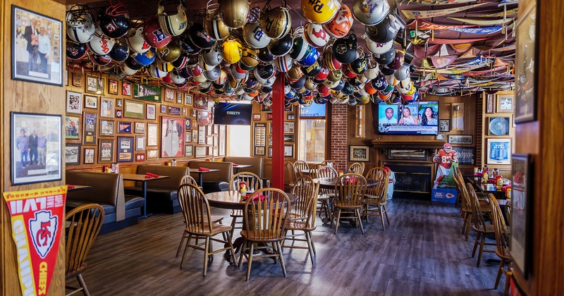 Interior space, dining area with impressive helmet collection hanging from the ceiling