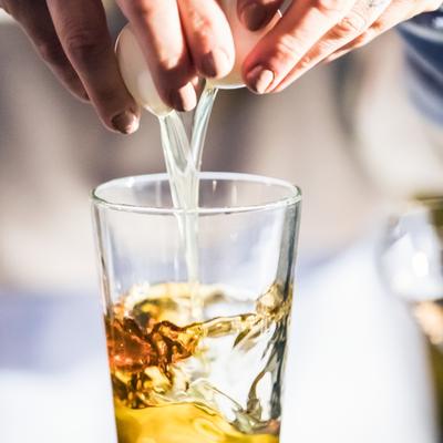 Bartender pouring a cocktail.