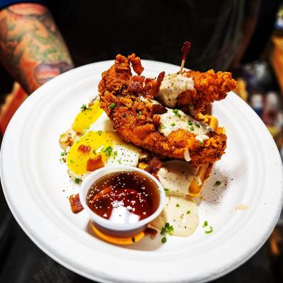 Fried chicken and waffle with eggs and syrup dressing