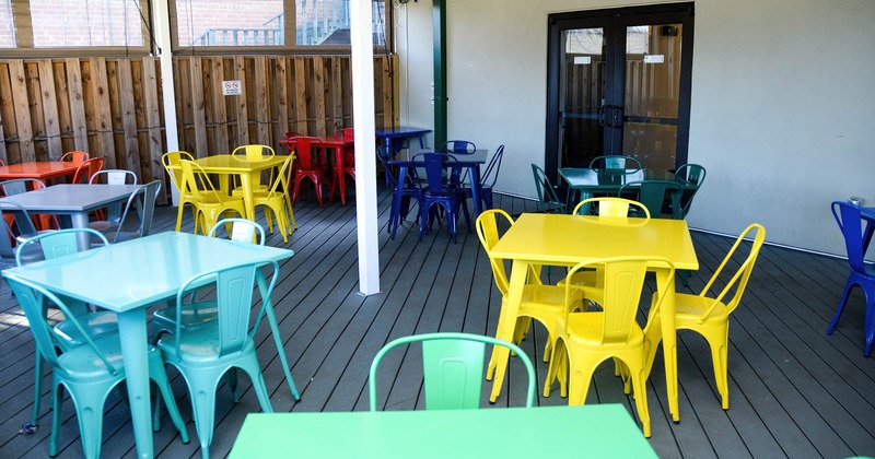 Covered patio area with chairs and tables