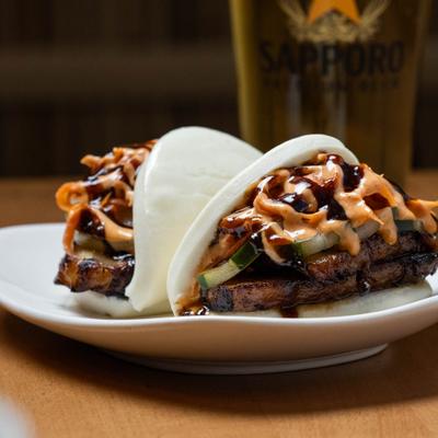 Pork belly buns, plated and served on the table.