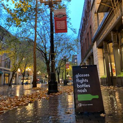 Outdoors, Locus Wines  A-frame signage placed on a side walk.