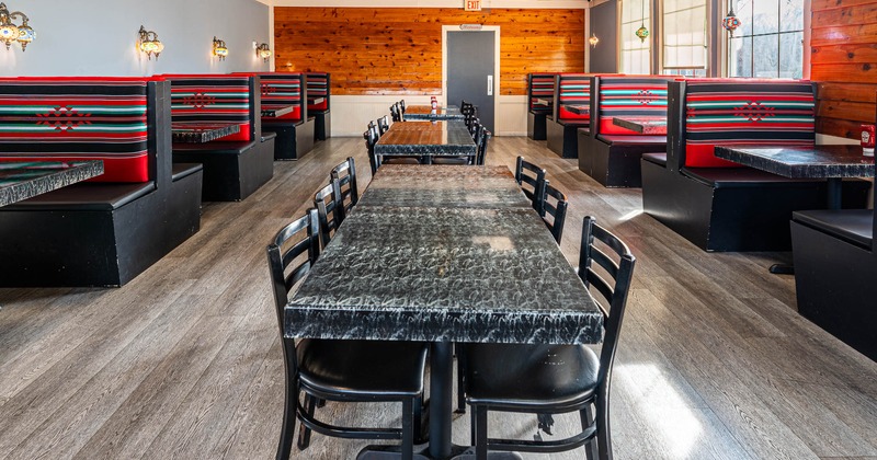 Interior seating area with chairs, tables and double booths