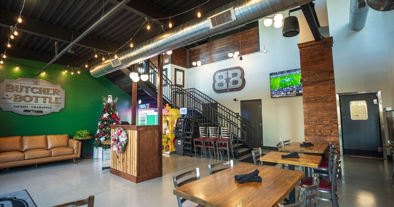 Industrial design interior - leather seating, a Christmas tree, host stand, dining tables and a TV