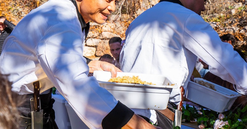 Staff members preparing food outdoors