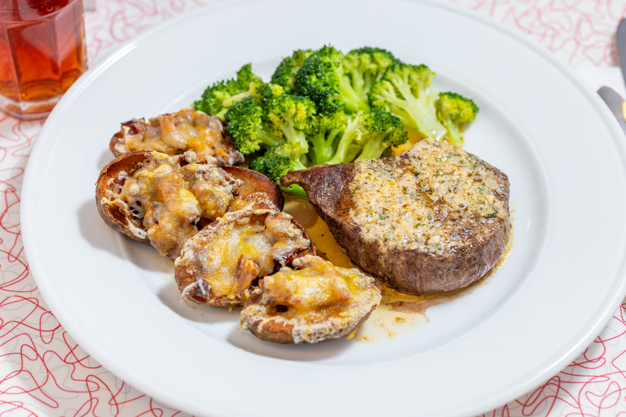 Filet Mignon with sides of potato skins and broccoli