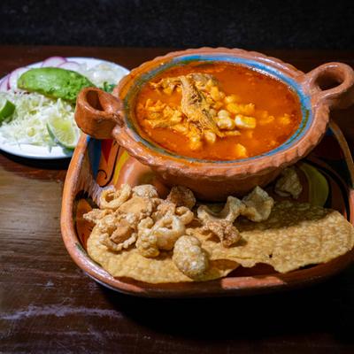 Pozole roja paired with pork rinds and corn tortillas.
