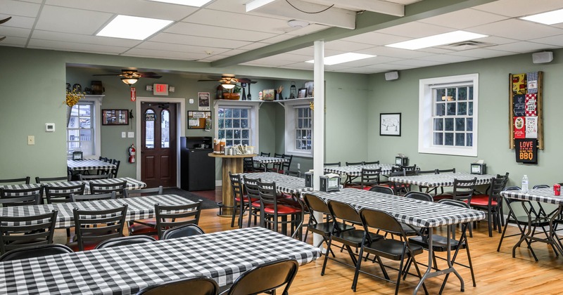 dining room filled with tables covered in black-and-white checkered tablecloths