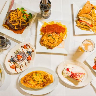 Assortment of dishes served on a table with drinks.