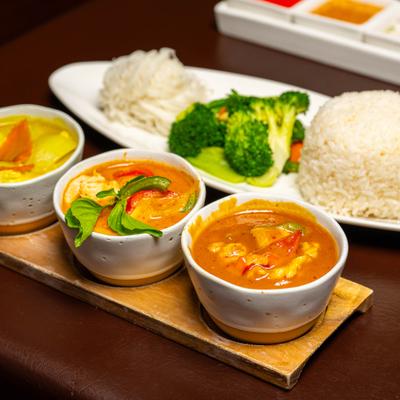 Curry Flight accompanied by steamed rice, noodles and broccoli.