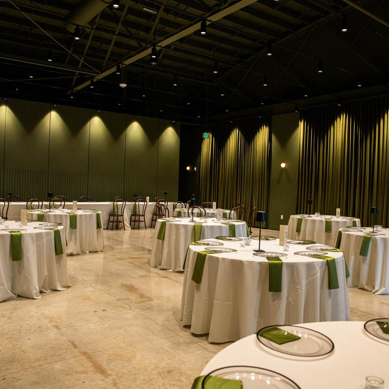 Interior, banquette room, round white cloth tables, ready for guests