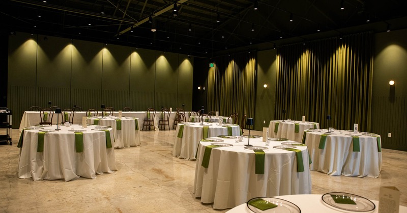 Interior, banquette room, round white cloth tables, ready for guests