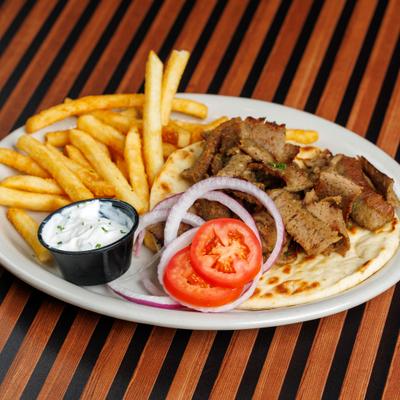 Gyros dinner with tzatziki and fries.