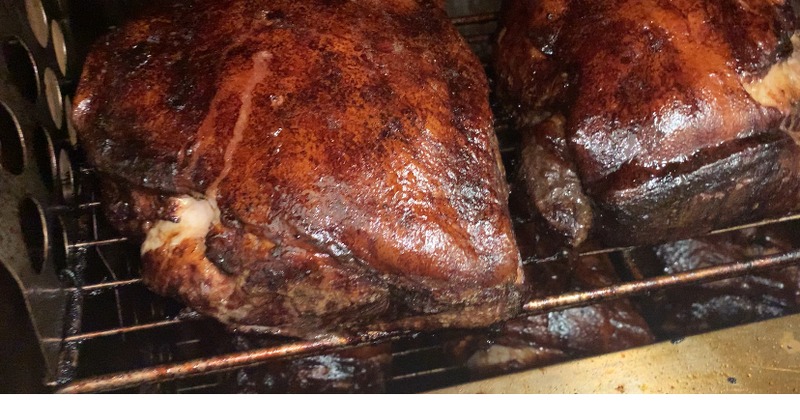 Smoked pork shoulders on a grill rack