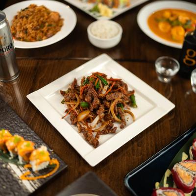 Crispy shredded beef served on the table alongside other dishes.