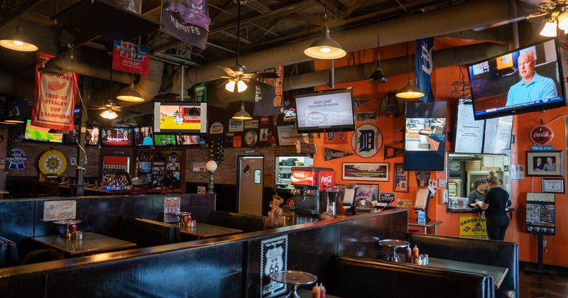 Interior, dining booths, TV screens and lots of decorations on walls