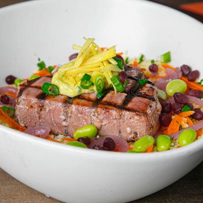 Grilled tuna on butter and herb couscous, with edamame, carrot, and pickled ginger.