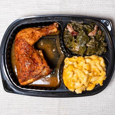 Baked chicken meal with macaroni and greens.