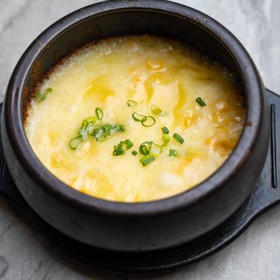 A bowl of corn cheese soup.