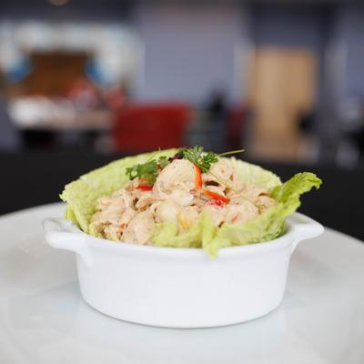 Chicken salad served in a lettuce lined bowl.
