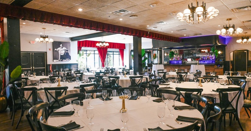 Interior, tables with tableware and chairs