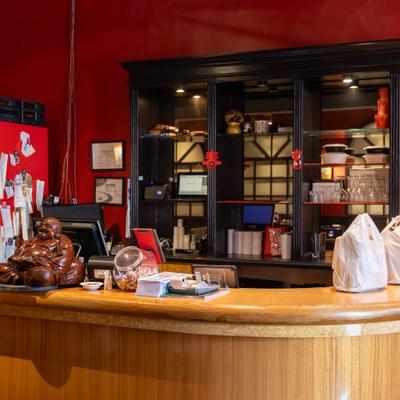 Front counter with decorative statue and storage shelves.
