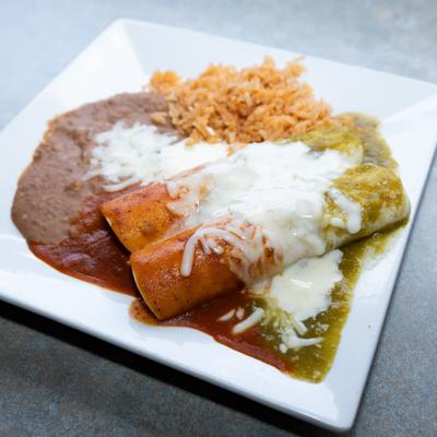 Enchiladas Tres Colores with sides of red rice and refried beans.