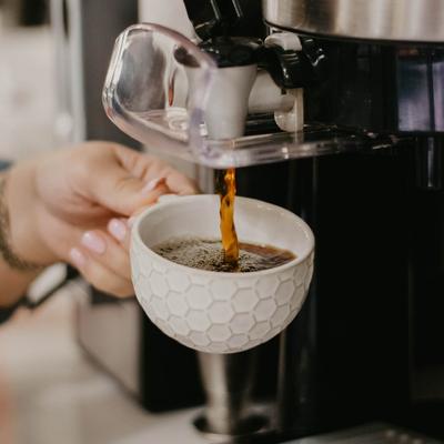 Pouring a cup of coffee.
