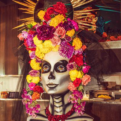 Interior, Day of the Dead bust sculpture with lots of colorful flowers