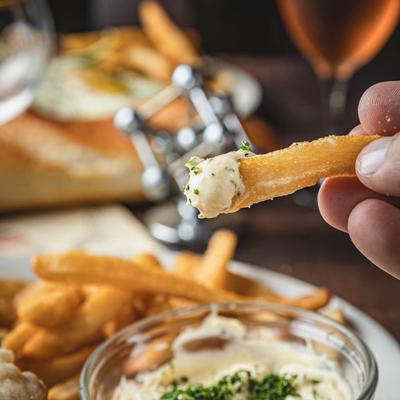 Dipped fry in a hand, close up.