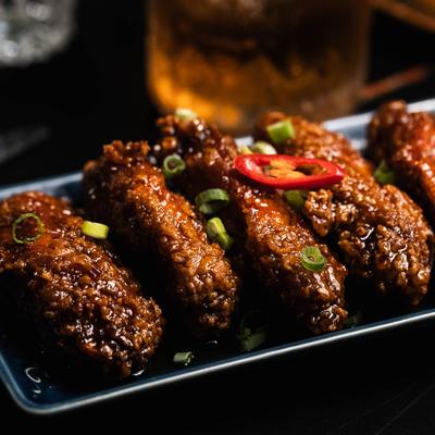 Fried chicken wings tossed in caramelized peanut-sesame sauce.